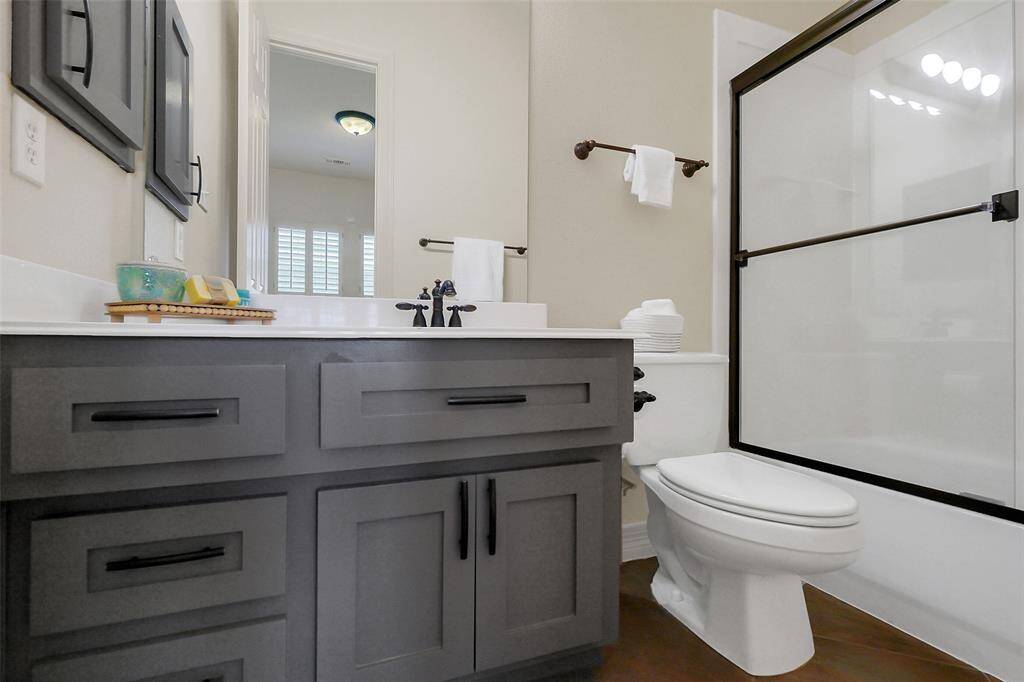 Private secondary bathroom with updated cabinets and in tub shower.