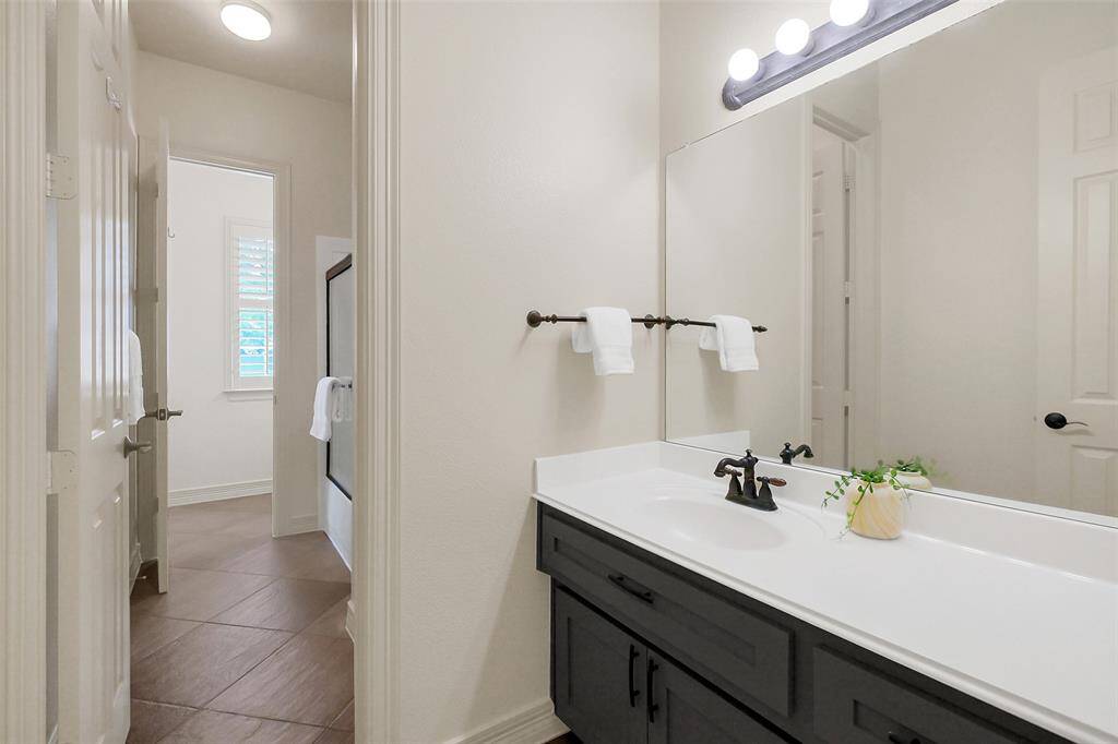 Access this side of the Jack and Jill bathroom from the hall. Sits just opposite of the other secondary bedroom.
