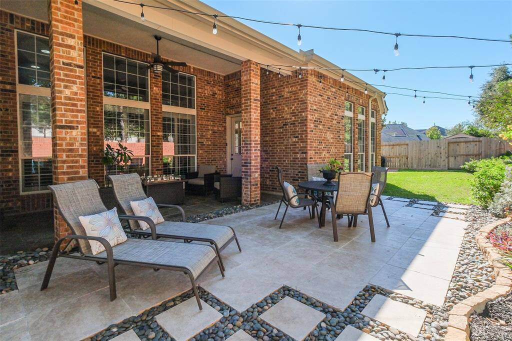 Covered seating area and extended patio in the back yard.