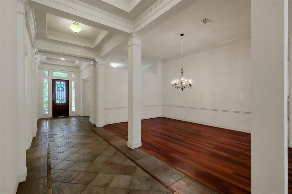 Formal living room/dining room with hardwood flooring.