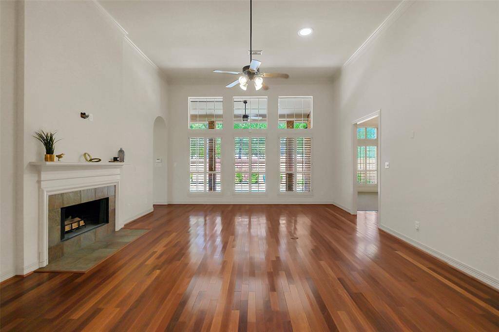 The living area is anchored around a cosy foreplace and has a wall of windows overlooking the back yard.