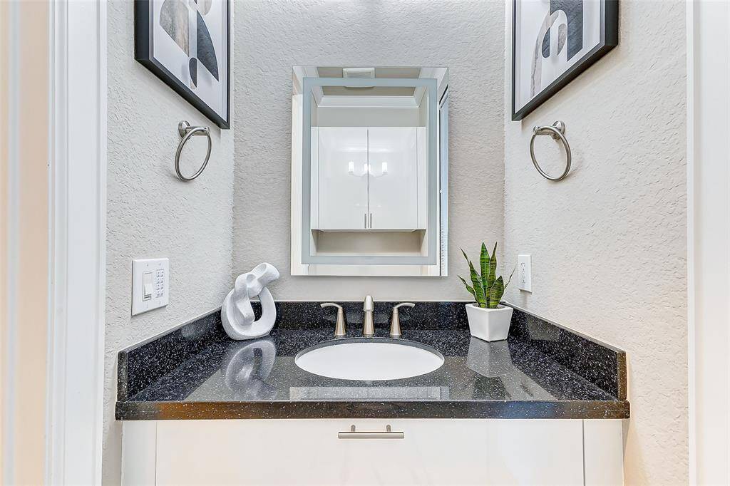 Indulge in this beautifully designed third bathroom that offers the perfect blend of functionality and comfort.
