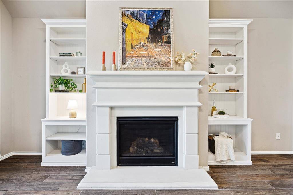 The centerpiece of the living area is this magnificent upgraded stone fireplace and mantle framed with custom lovingly made book shelves by the owner and his uncle with a TV bracket (behind the painting).