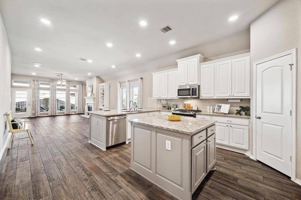 Contrasting island finish with storage and outlet for meal prep.Granite work space for rolling out the dough or home-made pasta.