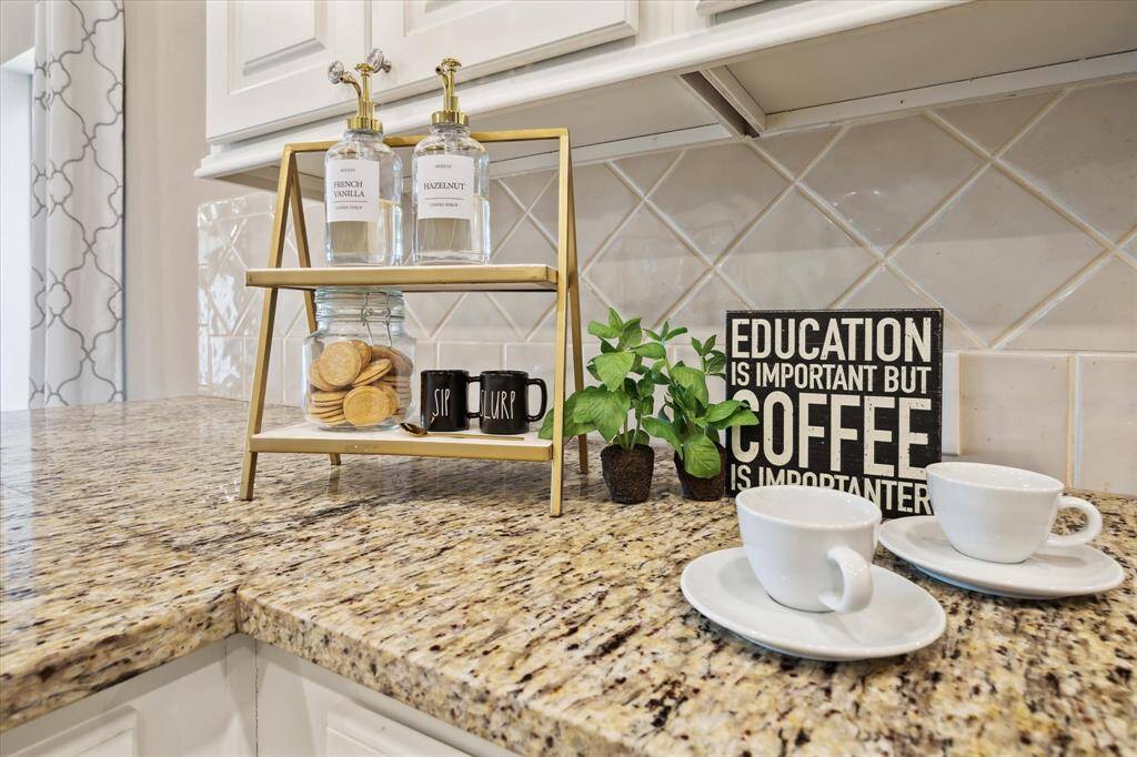 Meticulously chosen upgraded granite and back splash are a match made in heaven. The design choices of full length curtains, granite, tile, cabinetry and paint color are a feast for the eyes.