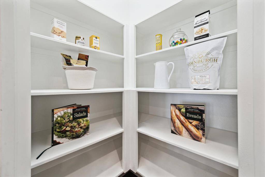 Kitchen corner pantry provides easy access and boasts ample shelving for storage. Stay organized and kitchen ready.