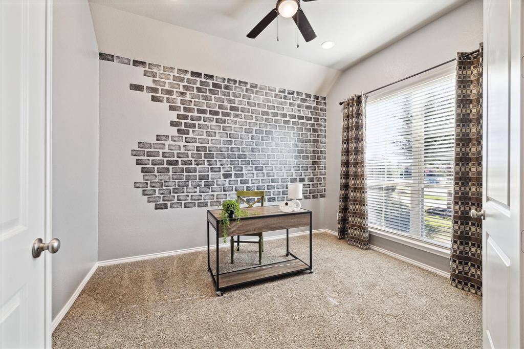 Front flex room can be the 4th bedroom, or with added French Doors become a home office. Urban vibe with hand stenciled bricks and coordinating full length curtains.