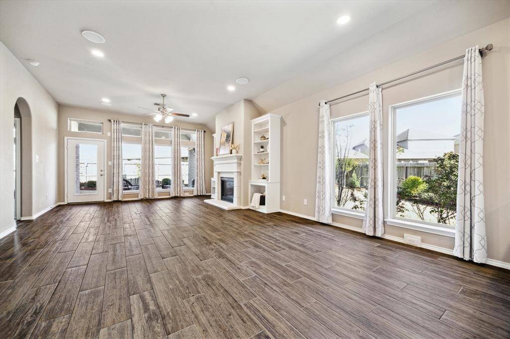 Expansive, open and light. Wood like tile flooring is easy to maintain. Window banks bring the outdoors in. This home has incredible outdoor landscaping that you will enjoy from all angels of your home.