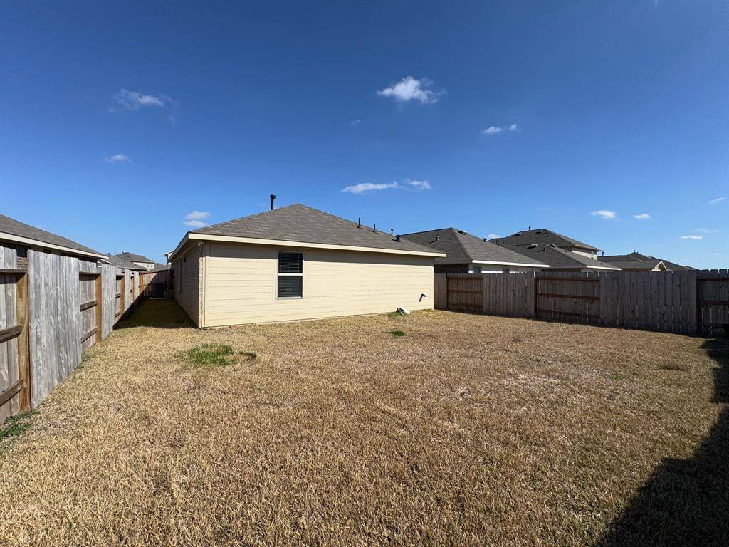 The spacious backyard offers plenty of room for outdoor activities
