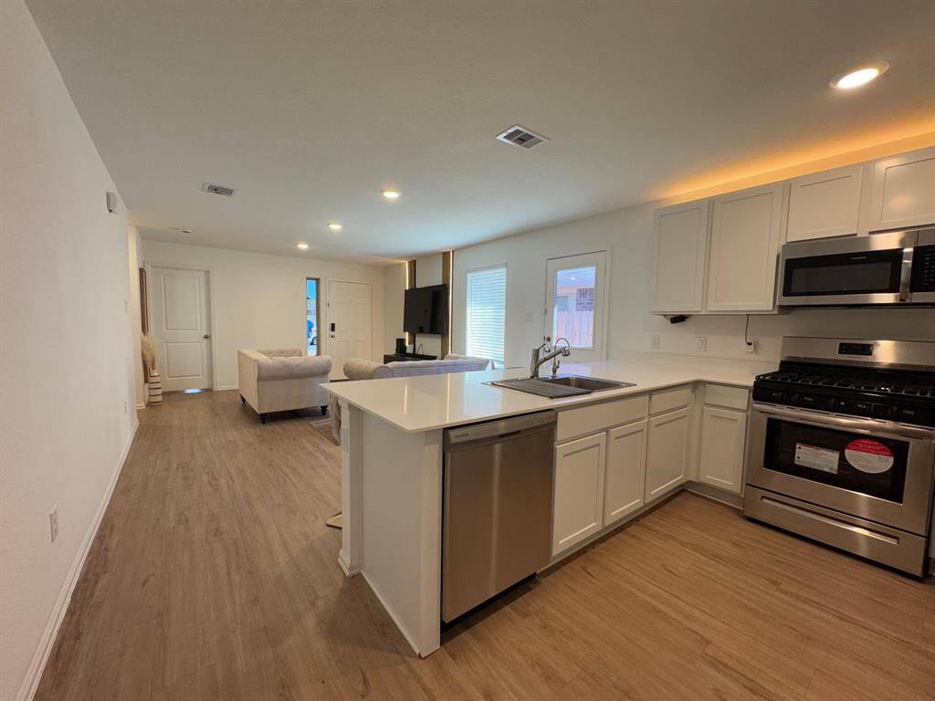 the kitchen flows into the family room