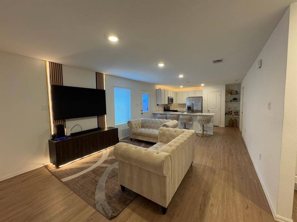 The open-concept design seamlessly connects the kitchen and living areas, creating a bright and inviting space that's perfect for entertaining, family gatherings, or everyday living.