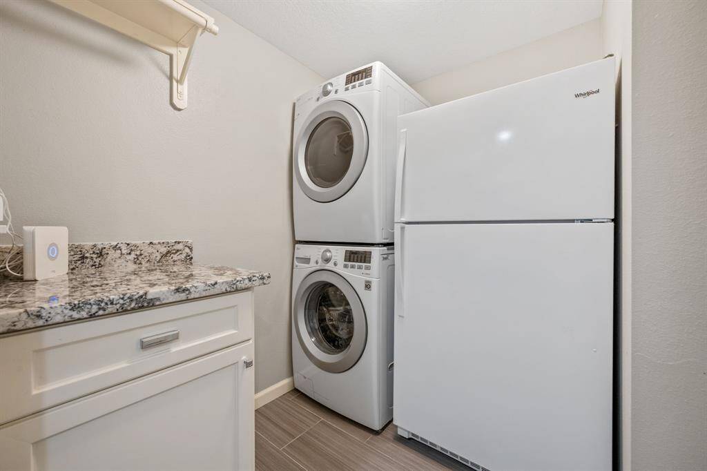 Laundry room. Washer/dryer and fridge remain.