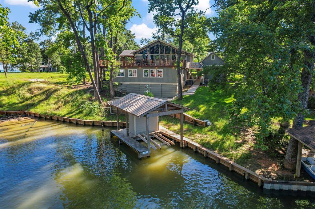 Rear of home and single stall boathouse. Currently set up for jet skis, but cradle can be changed to fit boat.