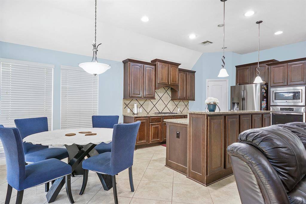 Notice the large window that give you a view of your covered patio. Easy access from the kitchen to back yard. This home would be great for entertaining.