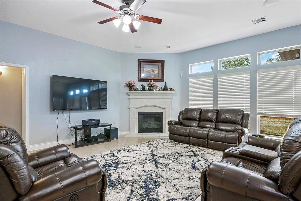 Living room with great natural lighting. Enjoy the view from the large backyard windows. Window treatments throughout this home.