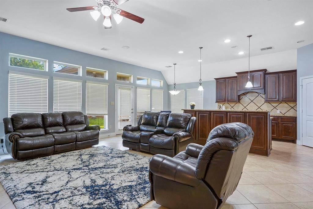 Open layout kitchen very roomy for friends and family gathering. Has currently over-sized bar stools that fit perfectly. Great pendant lighting. Beautiful home that is very well cared for!