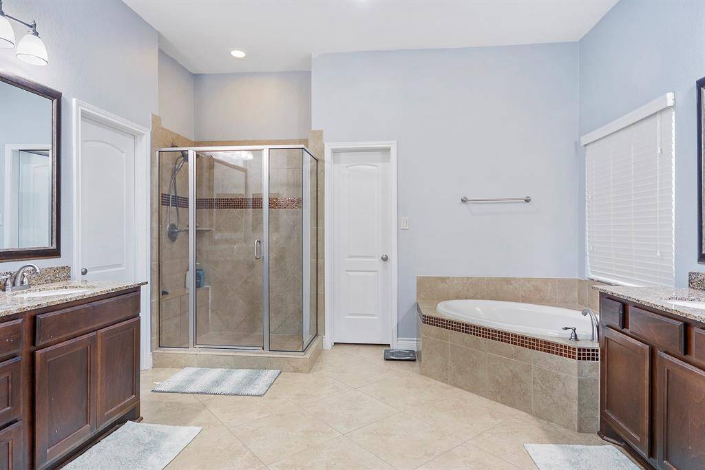Welcome to your luxurious Primary Bathroom. Featuring elegant soak bathtub, separate standing shower, separate sink and vanities, space cabinets, oil rubbed bronze fixture, walk-in closets, linen closet and a private water closet.
