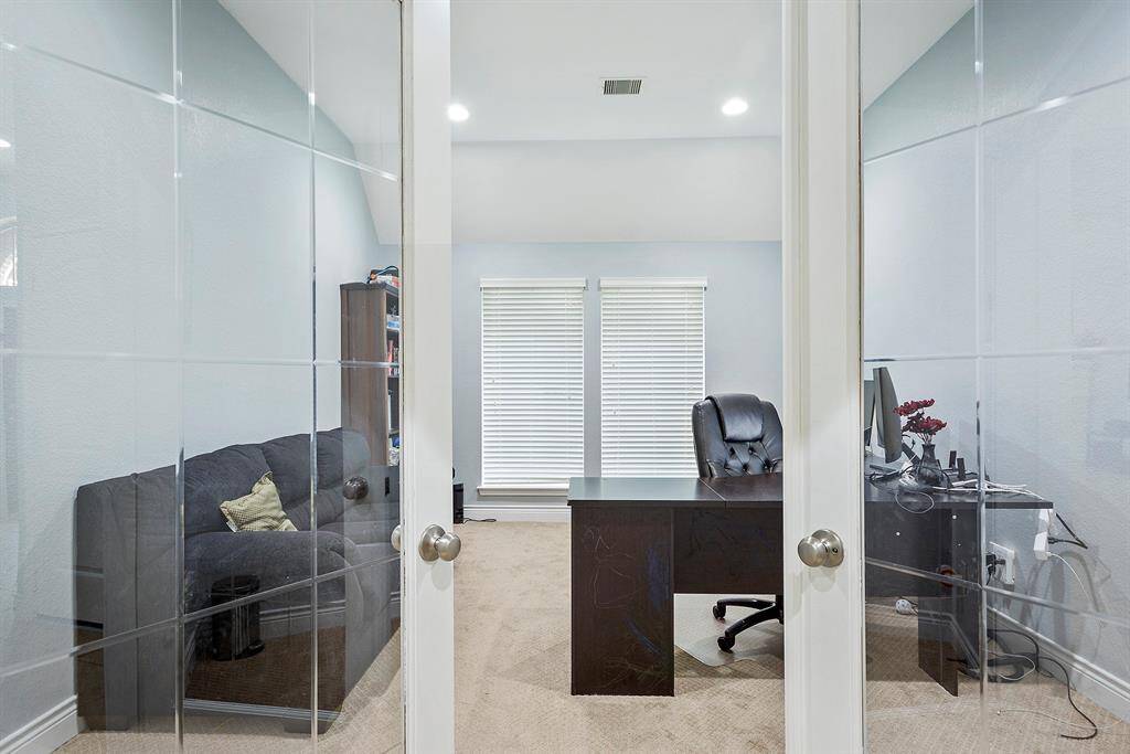 As you walk in, to your right are French Doors that lead into this private Home Office which offers great lighting and wood flooring. Large window views to the front yard.