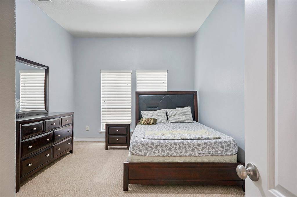 Guest Bedroom, this 1 of 4 bedrooms Has a walk-in closet and nice window with treatment. All bedrooms are on the main floor.