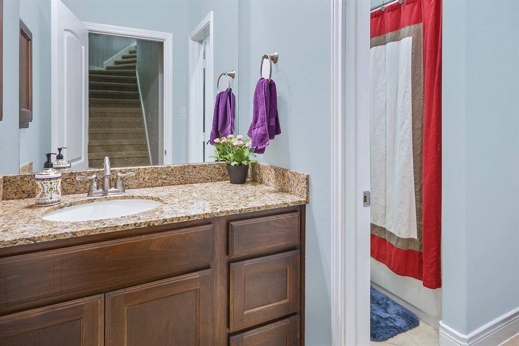 A view of  this guest bathroom. Offers a sink room has a door and connecting 2 piece bathroom.