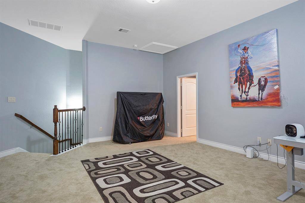 The oversized Game Room with front yard views. The door leads to the Media Room.