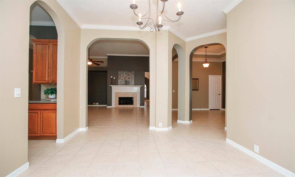 View from the formal dining RM with kitchen to the left and family room ahead.