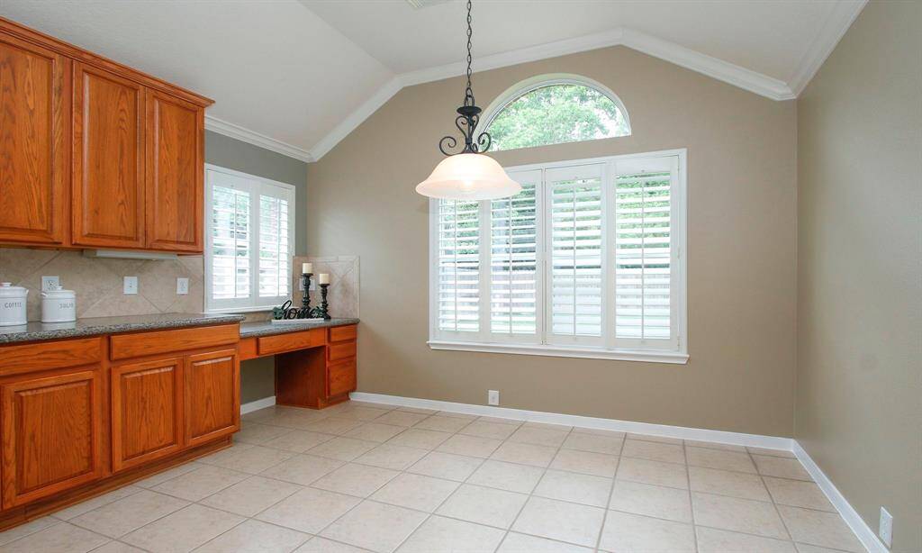 Light and bright breakfast area with views overlooking the backyard. Built-in desk on the left provides the perfect place to organize your favorite recipes.