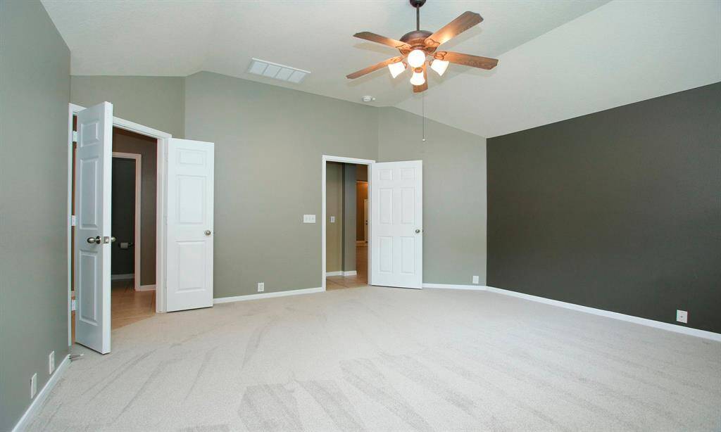 Primary suite sits to the back of the home and offers an abundance of space for all your furniture needs. En-suite bath to the left.