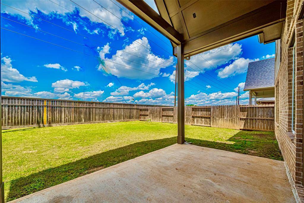 Back covered patio with gabled roof.