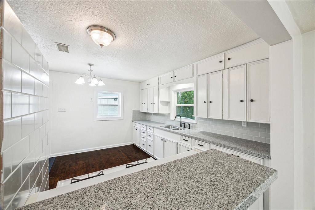 SMALL BREAKFAST BAR LOOKING INTO THE KITCHEN.