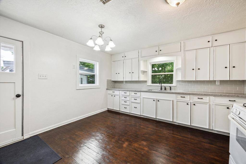 THE KITCHEN OFFERS A BREAKFAST NICHE AND DOOR TO THE PATIO/GARAGE.