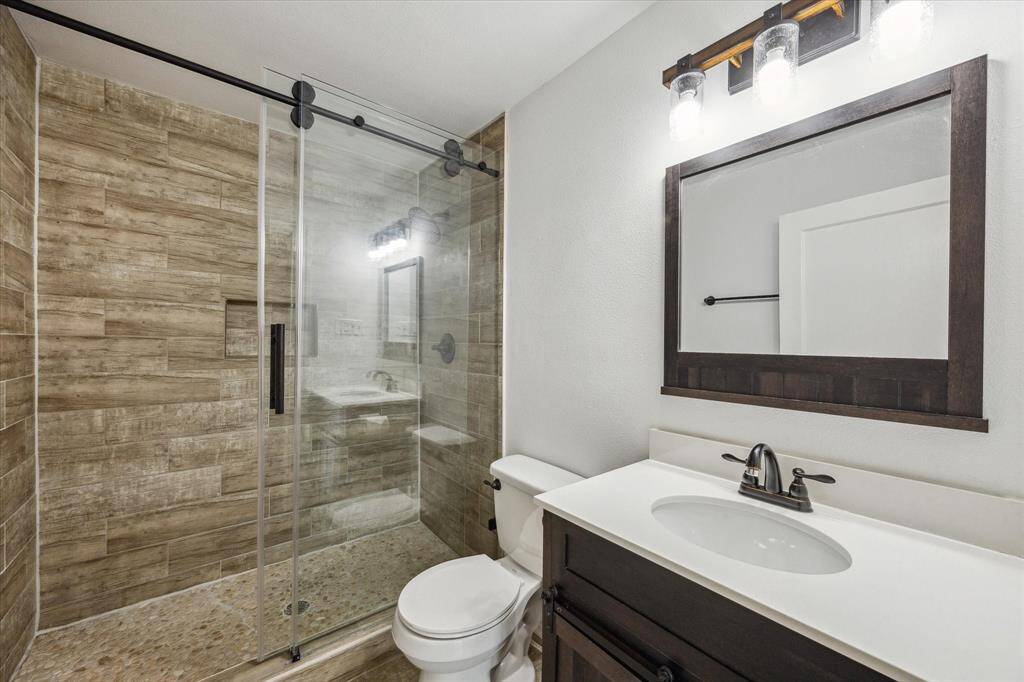 THE FULL BATH HAS BEEN UPDATED WITH A WALK-IN SHOWER WITH FLOOR TO CEILING TILE SURROUND.