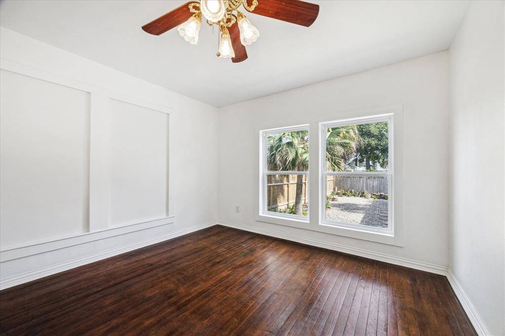 BACK BEDROOM WITH REACH-IN CLOSET AND CEILING FAN.