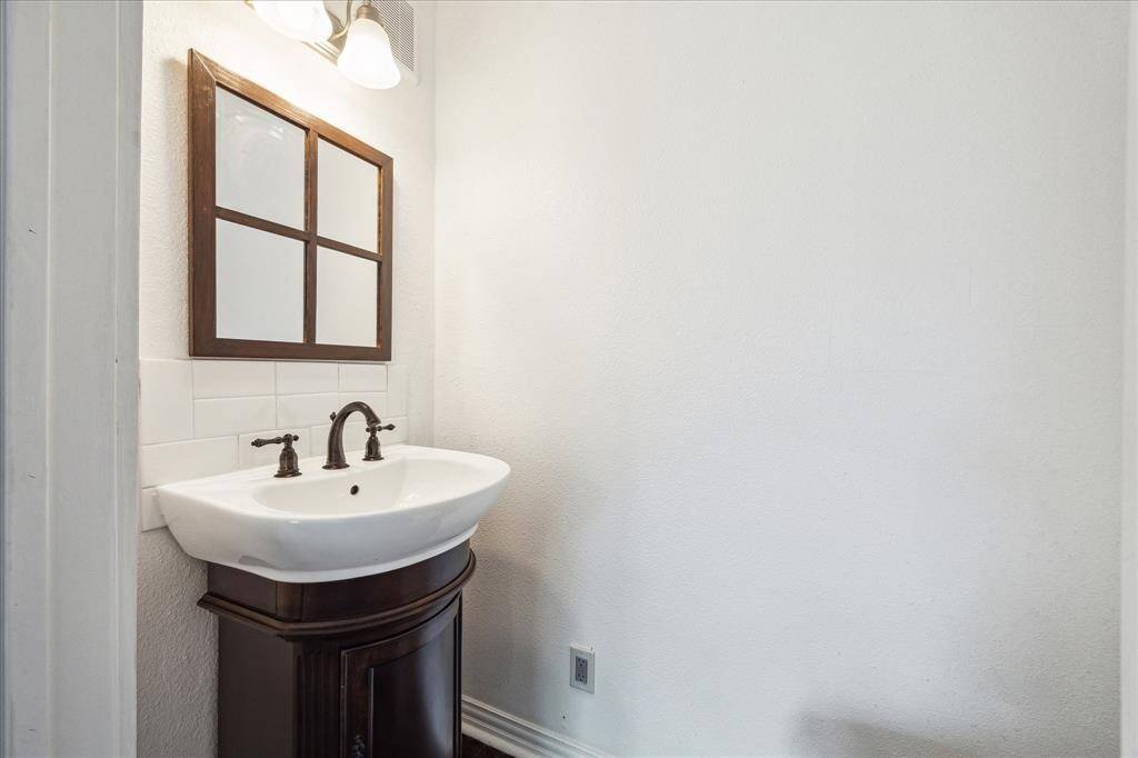 EN-SUITE HALF BATH WITH PEDESTAL SINK.