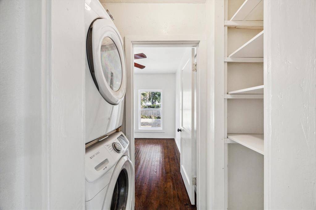 HALL UTILITY AREA WITH STORAGE AND STACKABLE WASHER AND DRYER.