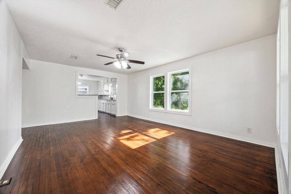 DEN WITH ORIGINAL WOOD FLOORS.