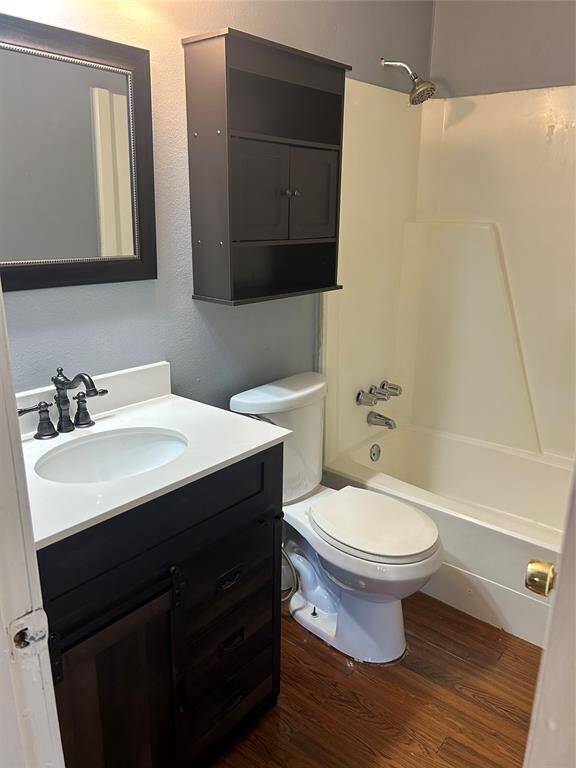 Bathroom with updated vanity and framed mirror.