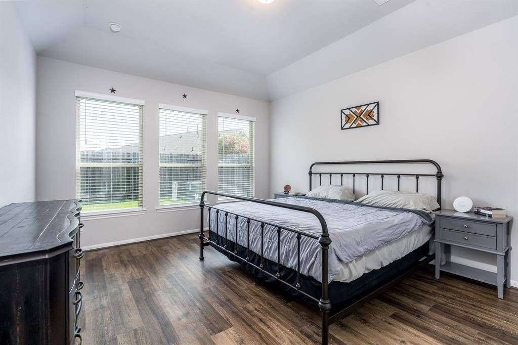 A serene primary bedroom with wall of window for all the natural light. Drifting off to sleep in this space is oh so dreamy!