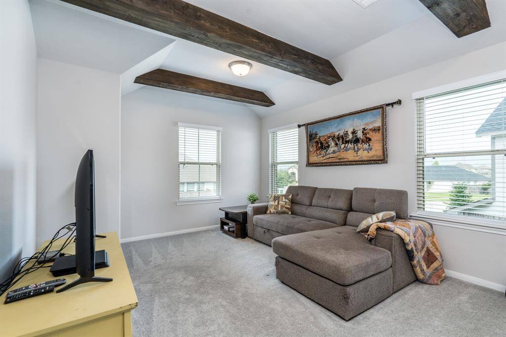 A large spacious game room is ready for whatever task you design it for! Check out the faux cedar beams...adds class!