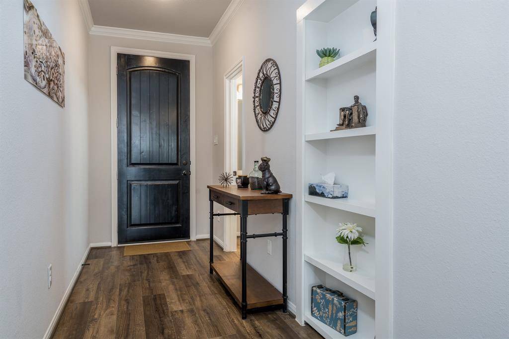 Just a little push and this bookshelf opens for additional storage. How neat is this!
