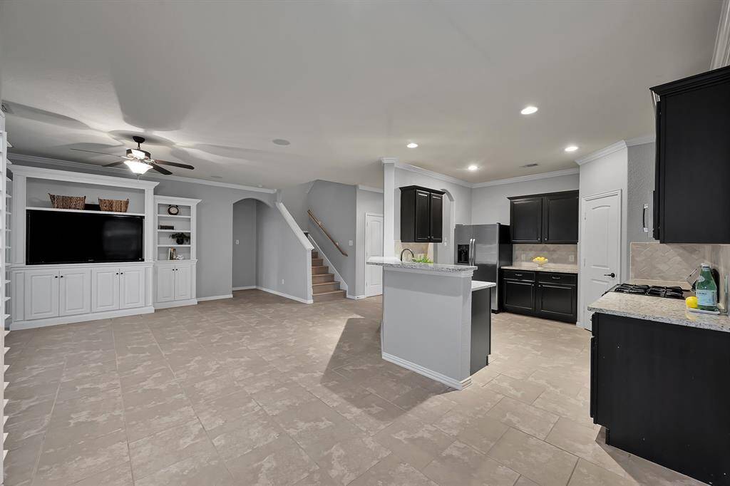Large Den open to Kitchen. Note the great Built-In that include Big Screen TV with sound system!