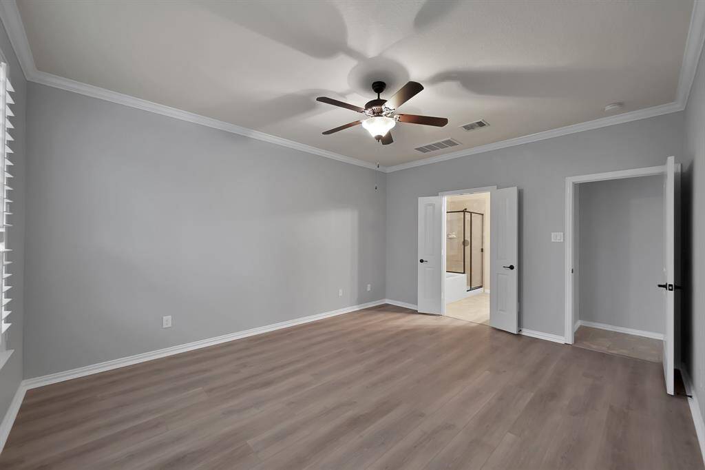 Alternate view of the Primary Suite looking toward the hallway and the ensuite.