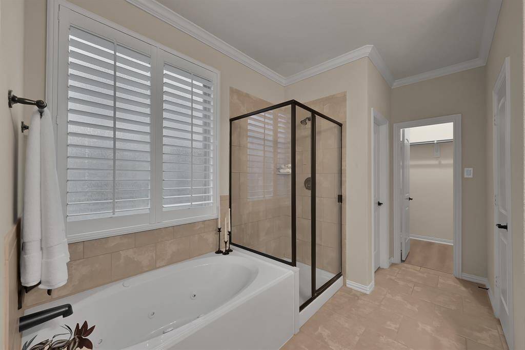Jetted soaking tub AND separate walk-in Shower. Notice the Plantation Shutters! There is a huge walk-in closet as well!