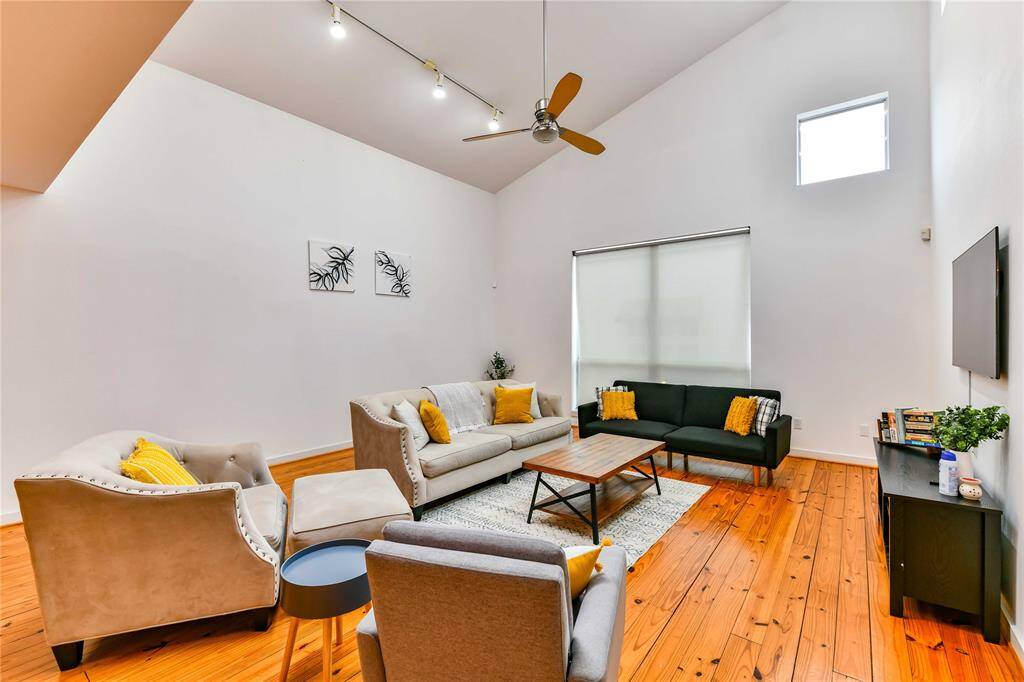 Main living area has a dramatic high ceiling.