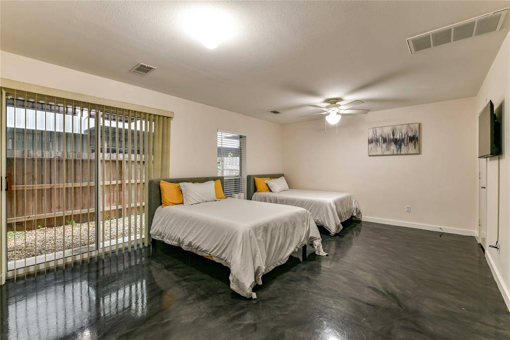 1st primary suite is on the first floor, very large with stained concrete floors and an en suite bathroom.