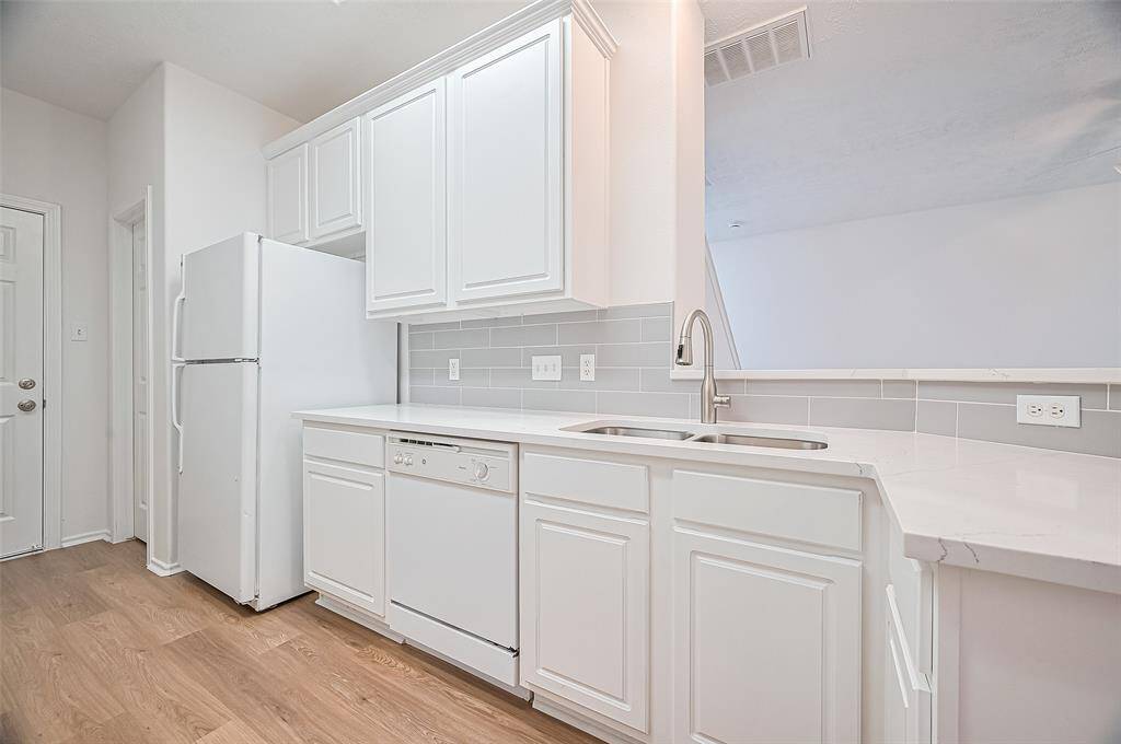 Experience seamless living with a kitchen that flows effortlessly into the living room.