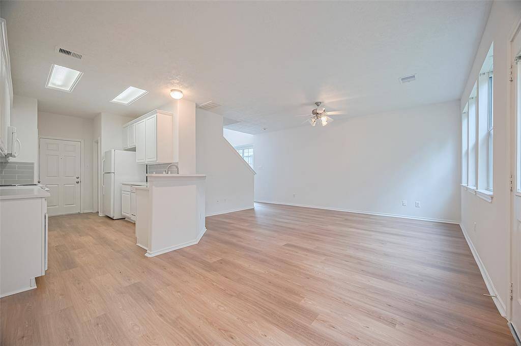 Enjoy seamless living with stylish vinyl floors and an open-concept layout connecting the living area to the kitchen.