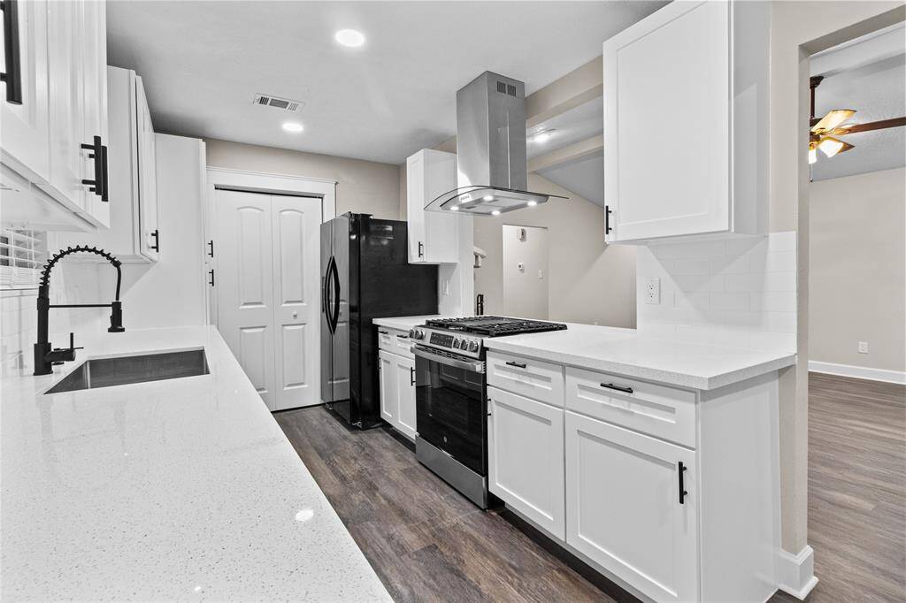 Closer view of the kitchen and appliances.