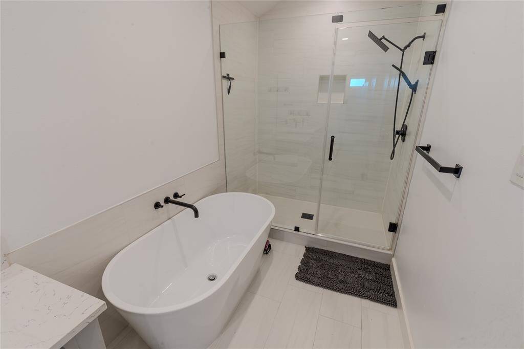 Oversized modern shower and separate soaking tub.