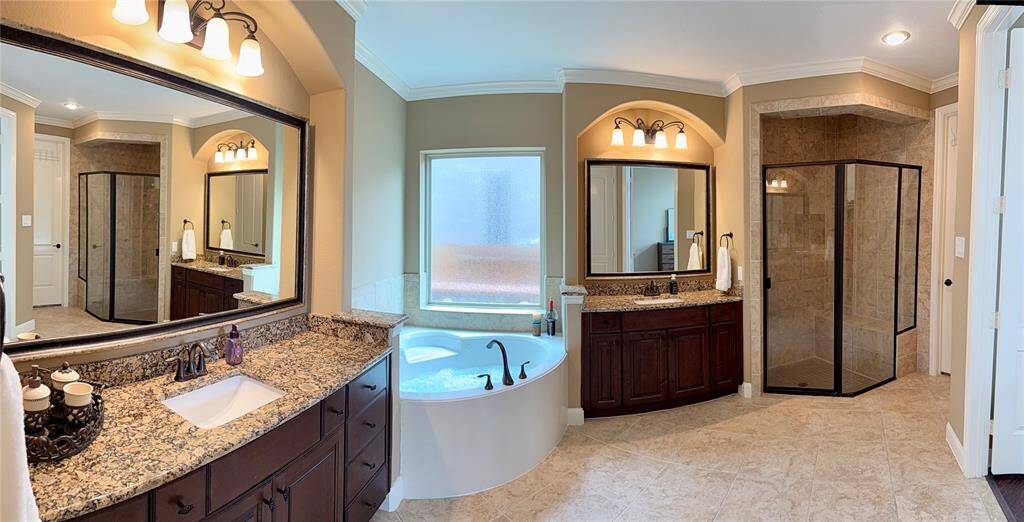 This bathroom is large and included a stand alone tiled shower,  his and her walk in closets!